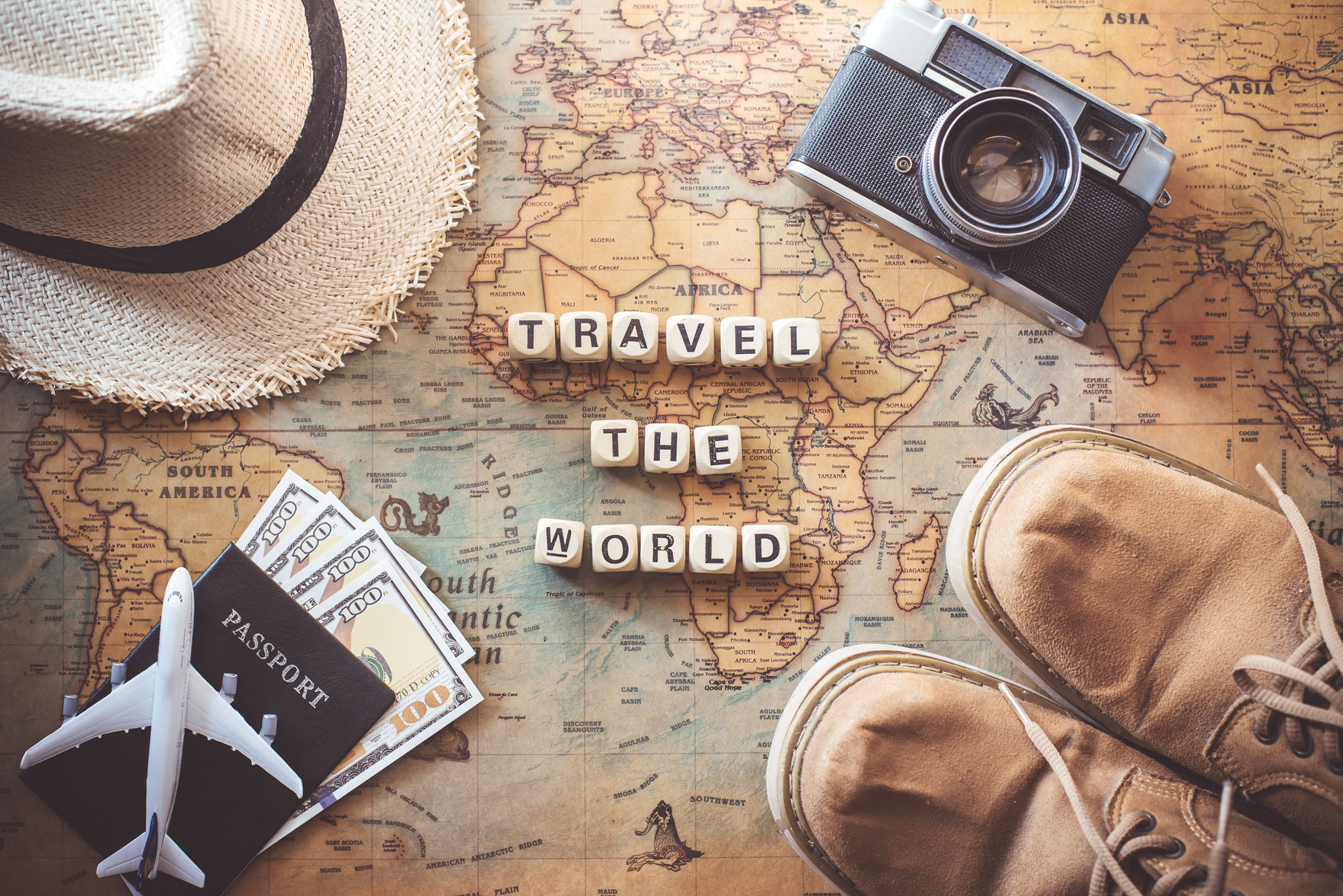 Words  "TRAVEL the WORLD" and Accessories for Travel Flatlay